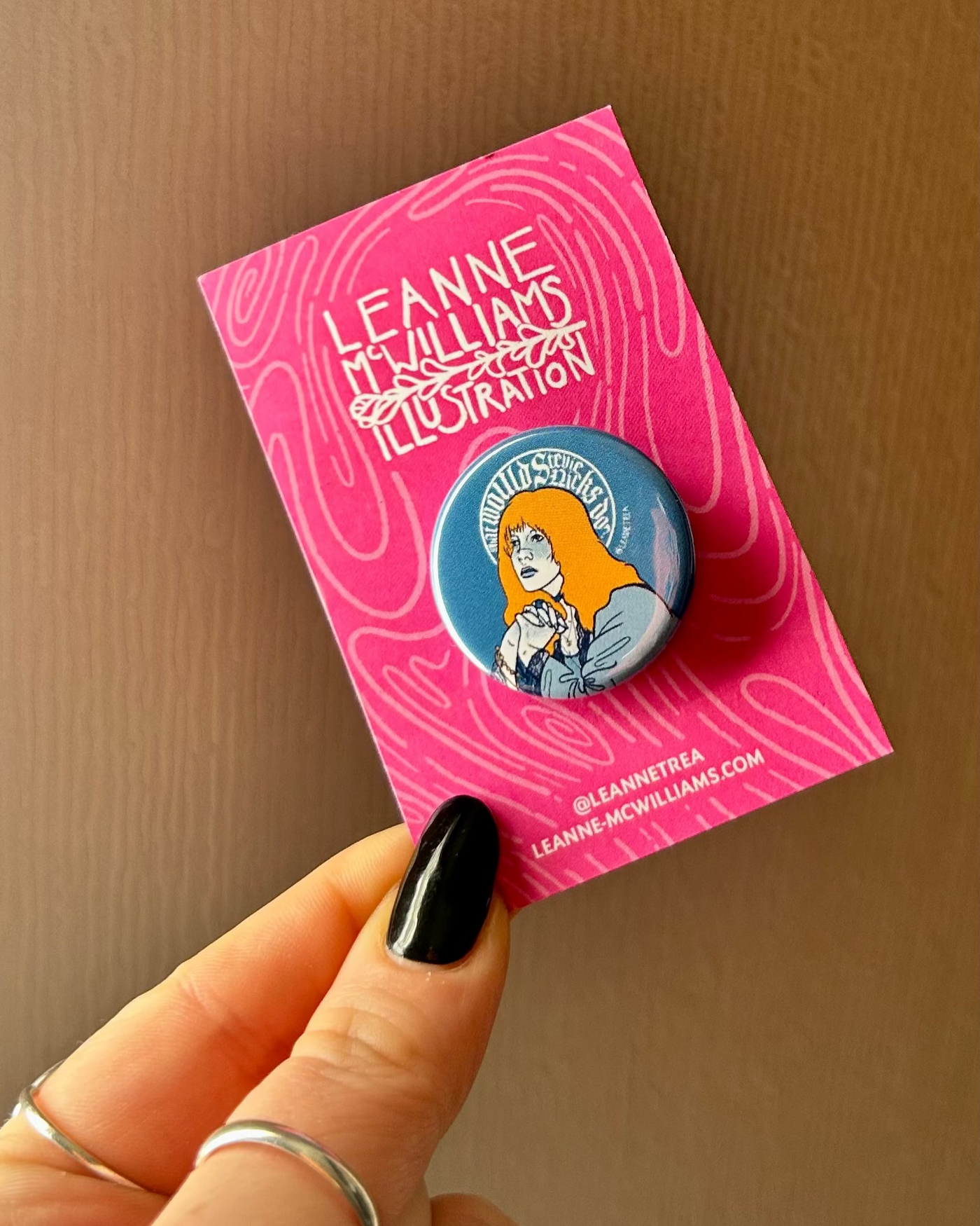Stevie Nicks button badge with illustration on pink card held by a hand